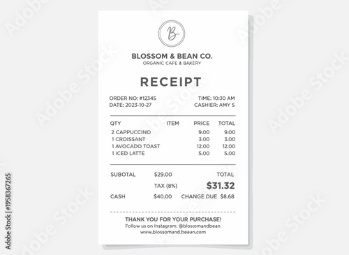 A receipt for food items purchased at a cafe with latte and croissant on a table indoors