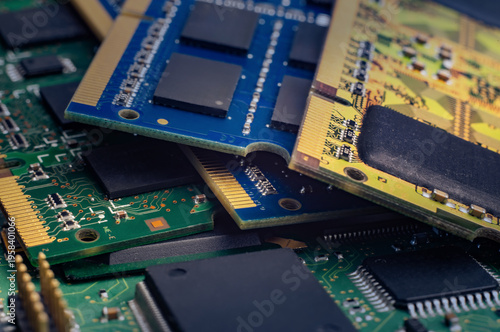 Close look at computer memory chips stacked together on a workbench in a tech workshop during daytime