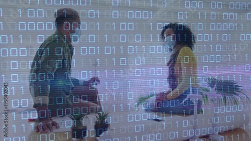 Animation of binary code over diverse coworkers in face masks in office