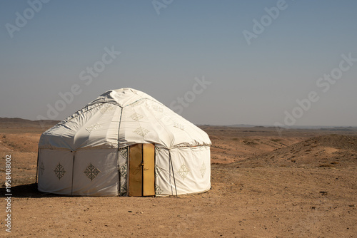 White felt yurts in the picturesque spring landscape of Central Asia. Traditional nomadic dwellings in the steppe