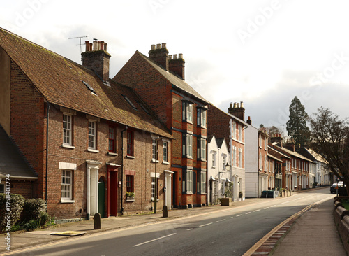 Berkhamsted historic town street with traditional brick houses under a cloudy sky in Hertfordshire, England