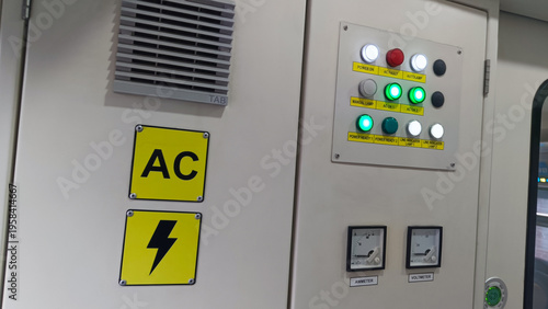 Electrical control panel with warning signs on train