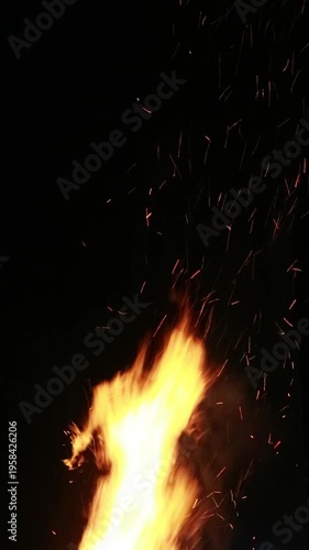 A vibrant flame burns brightly in a green activity setting promoting sustainability at home against a dark background