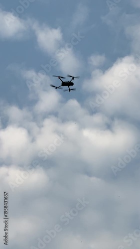 The footage shows a camera drone flying against the clear blue sky.