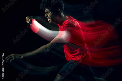 Table tennis player with dynamic motion blur showing rapid movement in dark studio. Concept of fast paced gameplay, high speed reaction, athletic performance and modern sports visual storytelling.