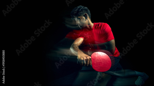 Принти на полотні Table tennis player hitting ball with motion blur in dark studio with copy space