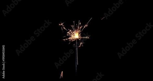Lightening sparkler on the black background. Sparkler concept. Bengal lights are burning on a black background. Holiday party concept. New year party sparkler. Slow motion.