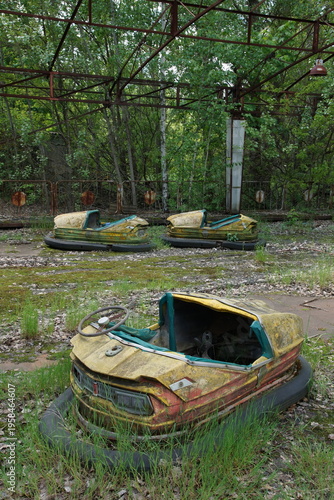 Fotografie Abandoned Bumper Cars at Amusement Park in Pripyat Ghost Town