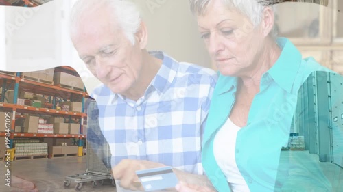 Animation of shapes over senior caucasian couple using laptop for online shopping