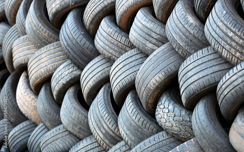 Old stacked vehicle tires, texture detail, recycling, automotive waste, rubber.