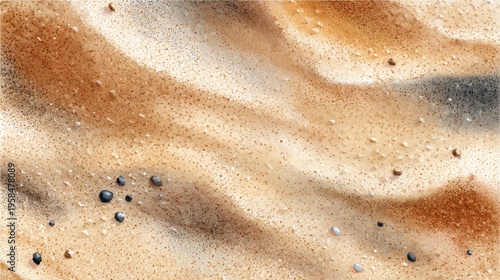 Close-up of textured sandy beach surface with small dark pebbles and tiny fragments in natural light