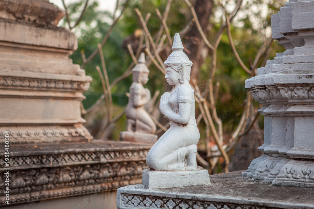 Fototapeta premium Detail of kneeling praying statues in Wat Svay Romeat Pagoda in Angkor, Siem Reap, Cambodia