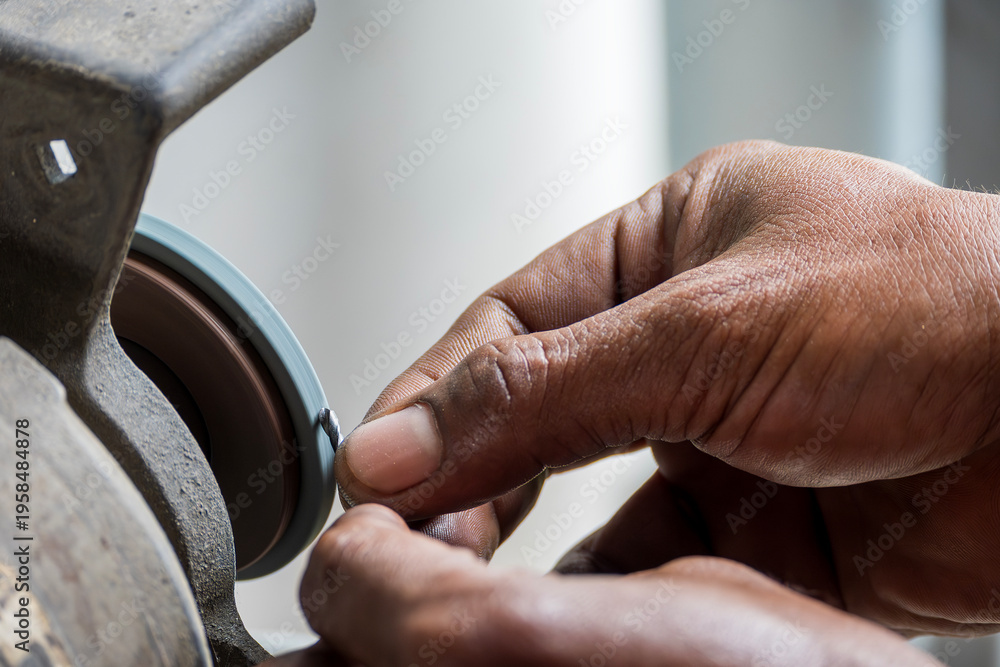 Photography Professional operator performing a precision small drill tool regrind process using an abrasive grinding wheel