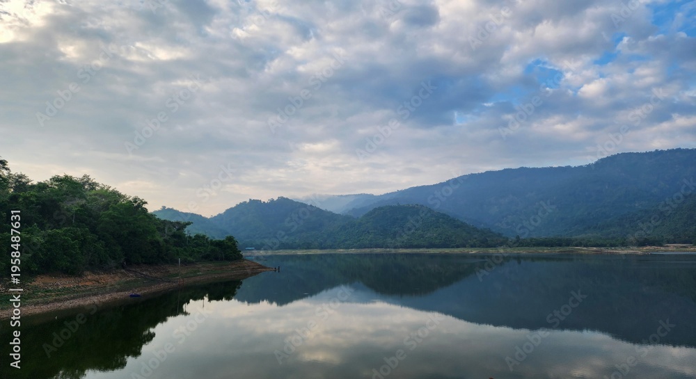 Fototapeta premium Peaceful lake landscape with mountain reflections at sunrise