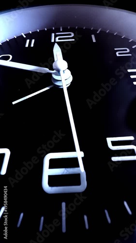 Vertical video social media - Macro closeup of a clock face with a sweeping second hand, and the time showing 11.49.