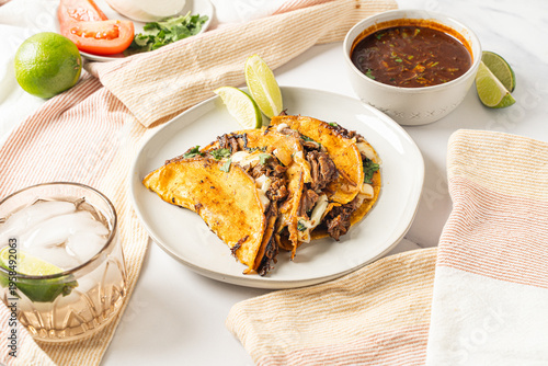 Birria tacos. Mexican food made with beef and a dipping sauce