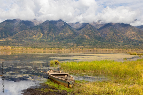 Wallpaper Mural Autumn Landscape with mountains, lake and old wooden boat Torontodigital.ca