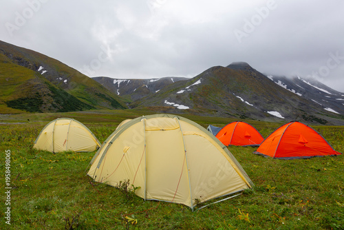 Wallpaper Mural Tourist tents stand on a large clearing in the mountains on a summer day Torontodigital.ca