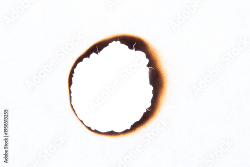 Fotografía Paper sheet with irregular burnt hole and dark scorch marks