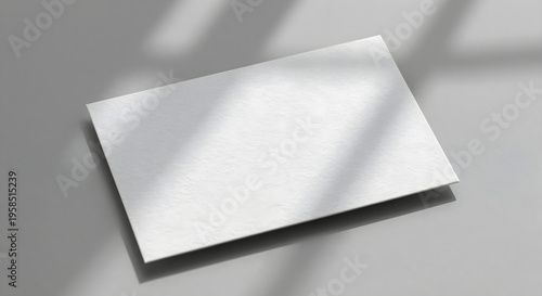 A white business card with a shadow on the surface