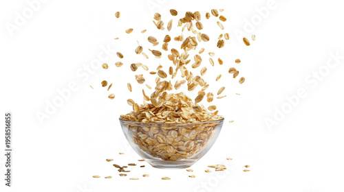 Oatmeal pouring into a clear glass bowl on a white background