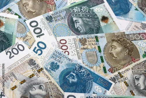 Polish zloty money bills pile on table. Poland banknotes of PLN currency close up.