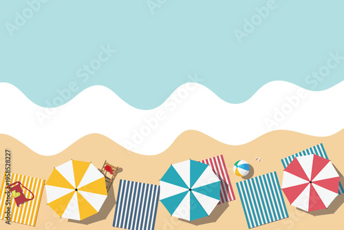 Beach scene with colorful umbrellas and towels on sand