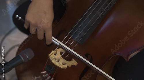 Close up of Musician Playing Cello with Bow in Orchestral Performance