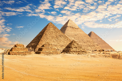 The Great Pyramids of Giza desert under a colorful sunset sky, Egypt