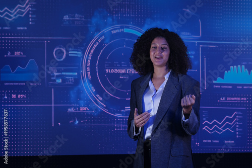 Young woman speaks about technology and data during a presentation in a modern setting with digital visuals in the background