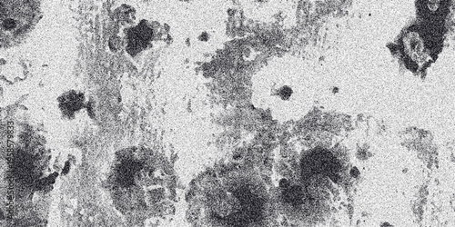Abstract grayscale speckled texture with organic blotches and granular noise creating a distressed, weathered, or microscopic surface effect for backgrounds