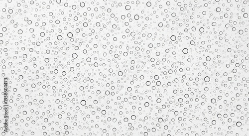 Black circles of various sizes on a white background texture pattern