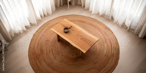 Overhead view of wooden coffee table on round jute rug