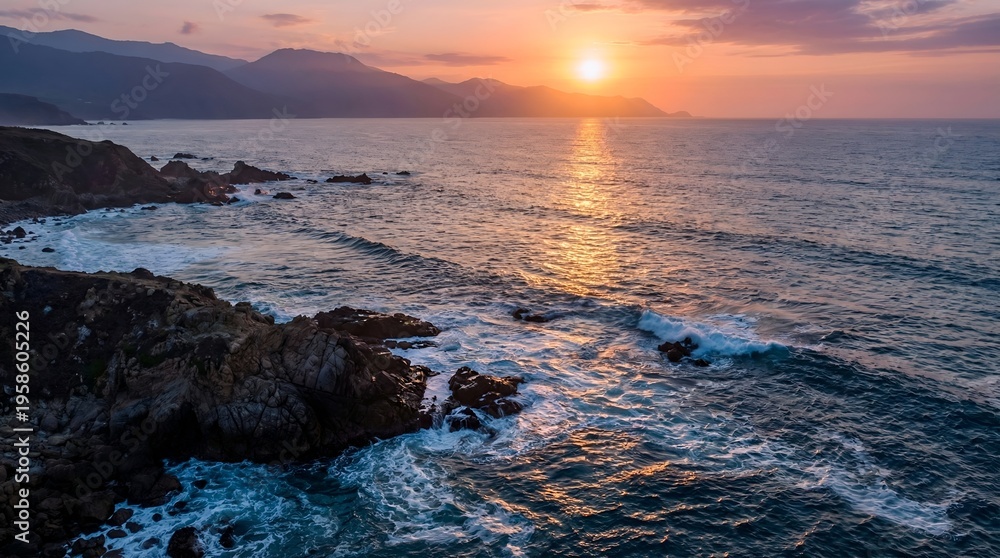 Obraz premium Coastal Sunset Over Rocky Shoreline with Ocean Waves breaking