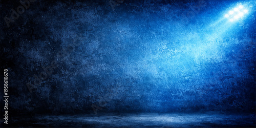 Empty stage with a vintage spotlight on a dark grunge concrete wall featuring a rough textured surface and old blue paper pattern