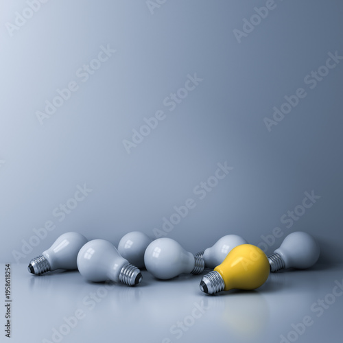 Foto Standing out from the crowd and the different concepts bright yellow idea bulb w