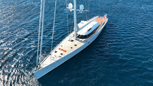 Aerial drone photo of beautiful sail boat anchored in deep blue Aegean Sea