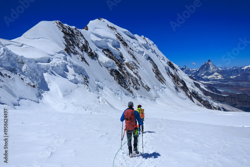 Foto Mountaineers in rope team with crampons descending on glacier Grenzgletscher and