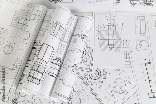 paper engineering drawings of industrial parts and mechanisms