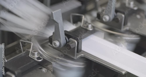 Spinning equipment, weaving machine, the jacquard loom is working. The parts of the mechanism move rhythmically, performing reciprocating movements. Close-up handheld shot, real time speed.