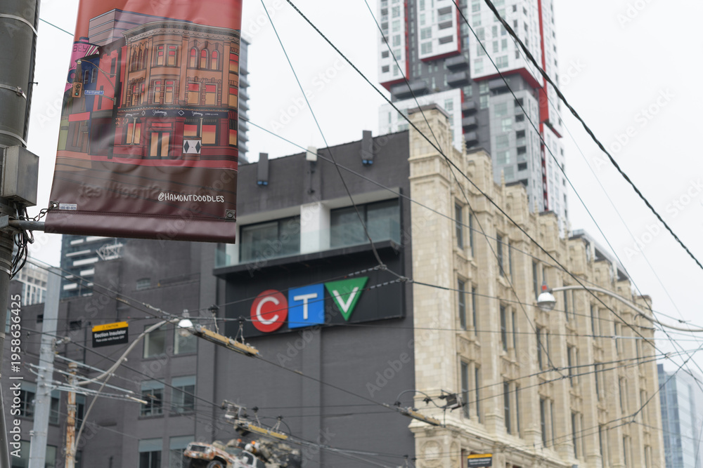 Obraz premium pole mounted banner for Queen Street West with defocused view of CTV and Bell Media building at 299 Queen W, Toronto