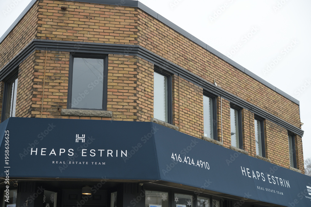 Obraz premium exterior building and sign of Heaps Estrin Real Estate Team, a real estate agency, located at 1391 Bayview Av, East York, Toronto