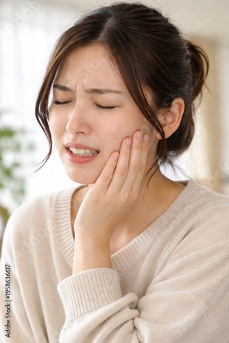 Tooth pain, dental problem, Young asian woman touching cheek with pain expression, toothache concept, close up portrait, soft natural light, healthcare and dental problem theme, realistic lifestyle