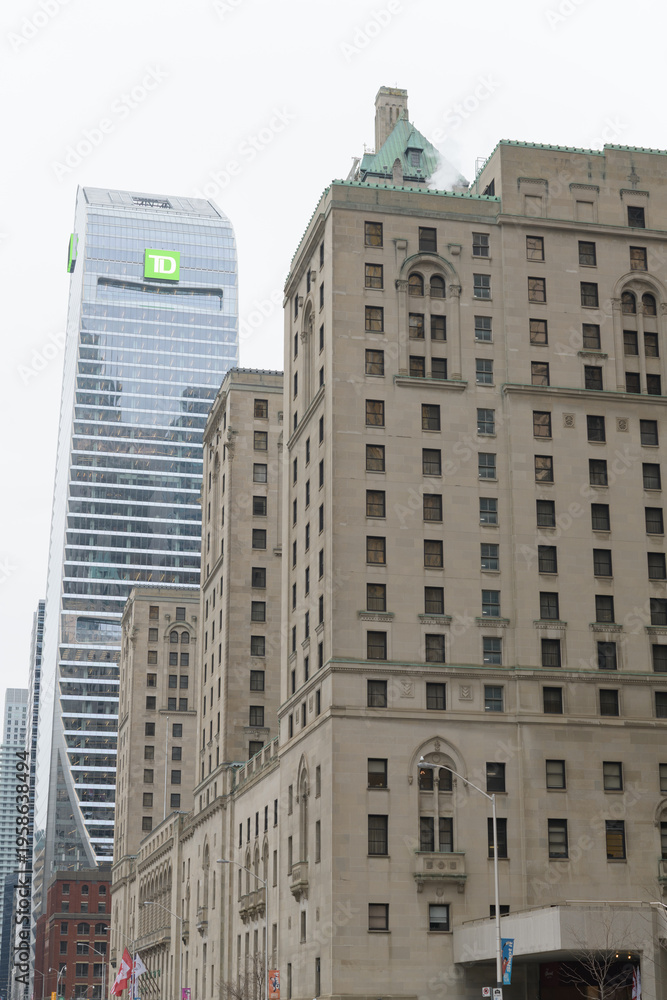Obraz premium looking west on Front St W from Bay St to Fairmont Royal York hotel and TD Terrace a corporate office tower, Toronto