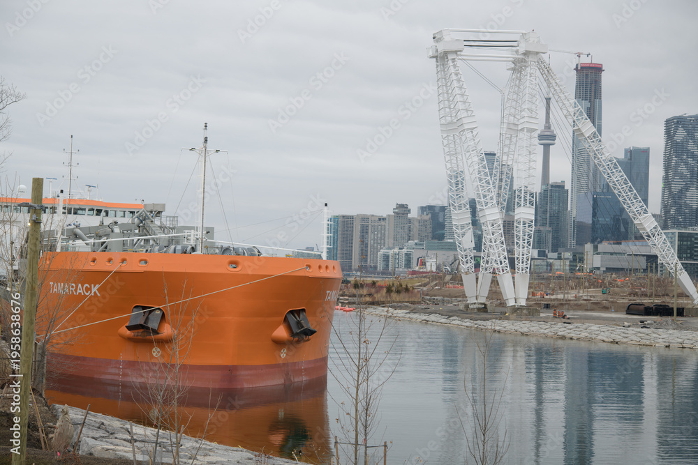 Fototapeta premium view of MV Tamarack (Canada Steamship Lines), a cement carrier, docked at Polson slip (Amrize, formerly Lafarge), from Cherry St, Port Lands, Toronto