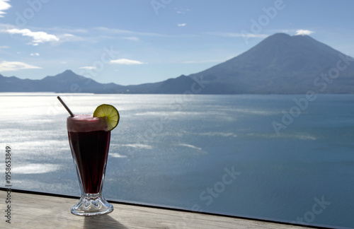 Wallpaper Mural Beverage with lime garnish set against a scenic lake atitlan and volcano backdrop, relaxation and travel lifestyle smoothie Torontodigital.ca