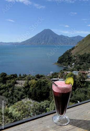 Wallpaper Mural Beverage with lime garnish set against a scenic lake atitlan and volcano backdrop, relaxation and travel lifestyle smoothie Torontodigital.ca