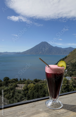Wallpaper Mural Beverage with lime garnish set against a scenic lake atitlan and volcano backdrop, relaxation and travel lifestyle smoothie Torontodigital.ca
