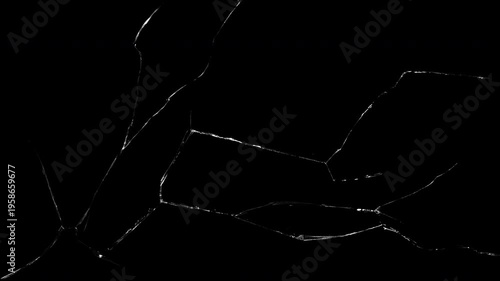 Large expanding glass crack spreading across surface with realistic fracture patterns and sharp shards, captured as a high-contrast overlay for impact VFX