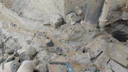 Construction Site with Metal Pipe and Muddy Ground